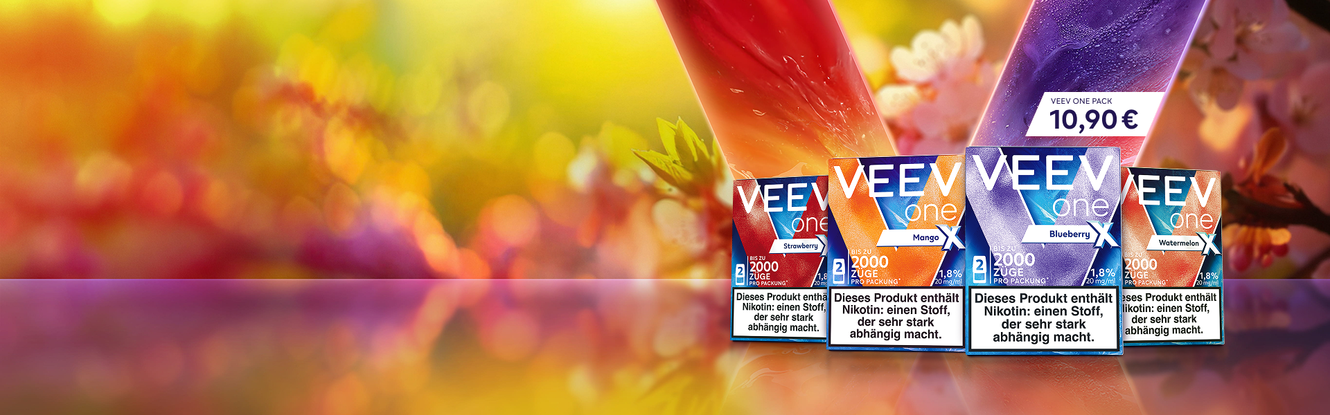 4 Packs Strawberry X, Mango X, Blueberry X und Watermelon X vor einem blumigen Hintergrund